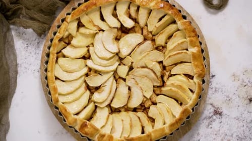 Homemade Delicious Apple Cake with Raisins and Cinnamon Over Stone Background Top View