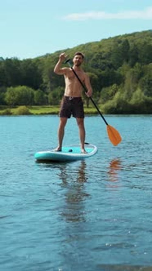 Man on Paddleboard on Lake