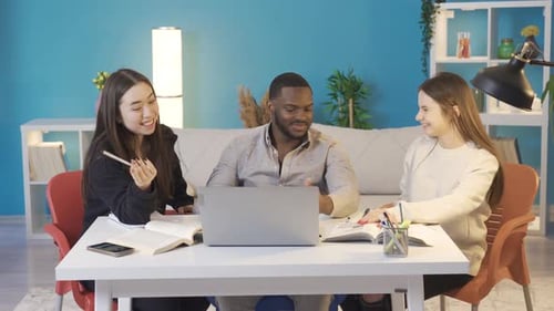 Multiethnic college group studying at home. Friendly environment.