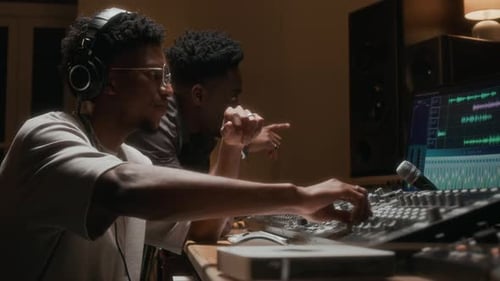 Artists at Mixing Console in Recording Studio