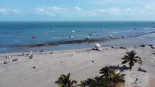 traveling forward with drone entering greenish sea with several boats on the coast, beautiful light,