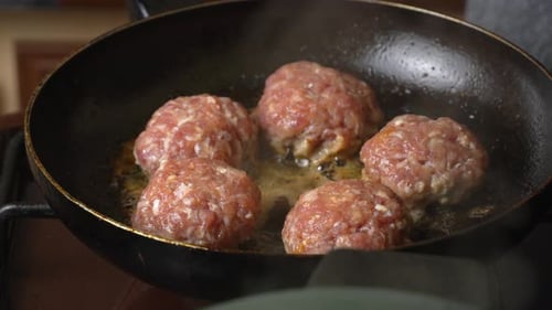 Meat patties or cutlets in form of cutlets, fried in oil in pan,