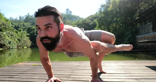 Man practicing Yoga outdoors. Person exercising physique