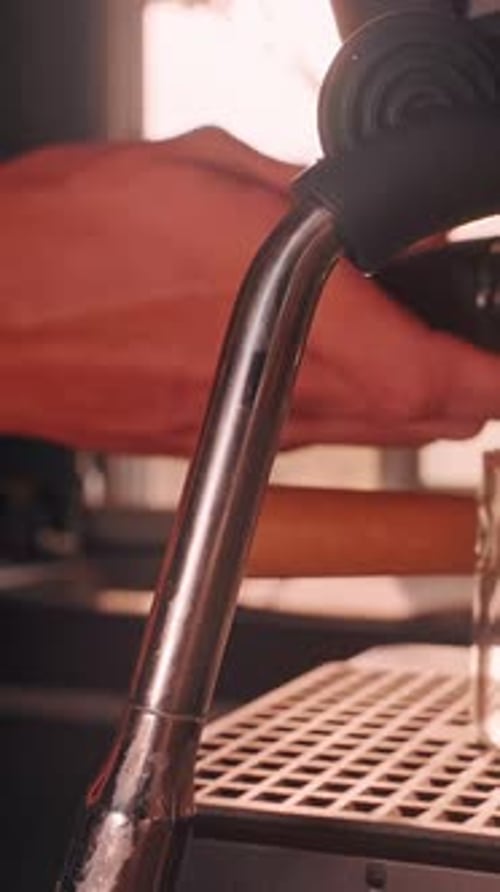 Vertical video. Barista Hand Installing Portafilter into Espresso Machine in Slow Motion, Close View