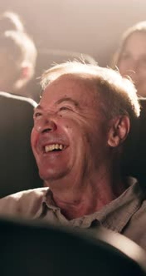 Senior, happy man and laughing with movie at cinema for comedy show, humor or entertainment