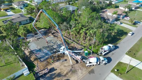 Construction Workers Pouring Cement Foundation, Aerial View