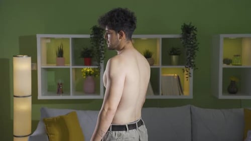 Distressed Young Man Poses in Living Room