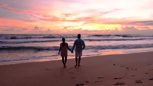 Couple of Men and Woman on the Beach at Sunset By the Ocean of Phuket Thailand