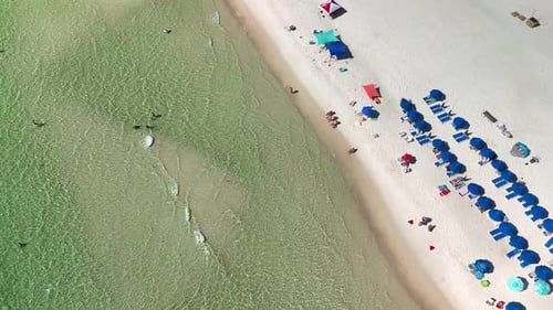 Beachgoers Swim and Sunbathe Under The Sun At The Beach On Panama City Beach In Florida, USA. - aeri
