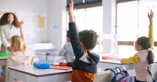 Young Students Raising Hands in Elementary Classroom