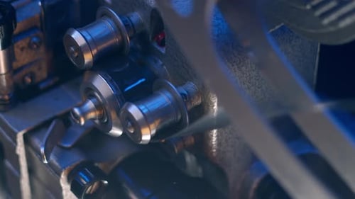 Film Reel Moving Through Projector Mechanism