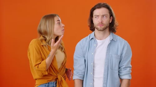 Woman Shares Secret With Man, Points to Side