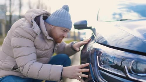 Anger and Irritation a Man Inspects a Car with Scratches