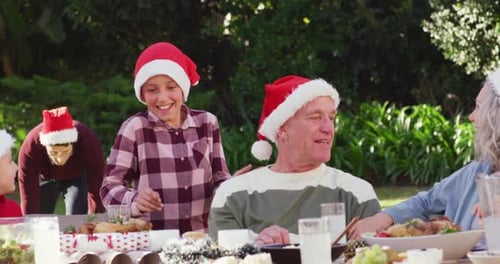 Happy caucasian family having christmas dinner in garden