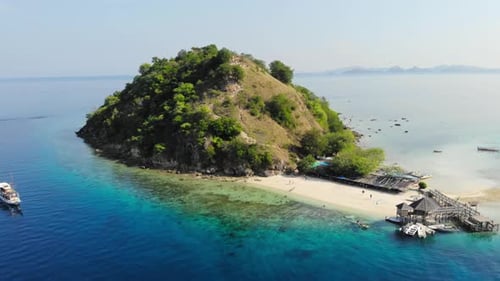 Aerial shot of Pulau Kelor island in Indonesia, Asia. The drone approaches the island, providing a c