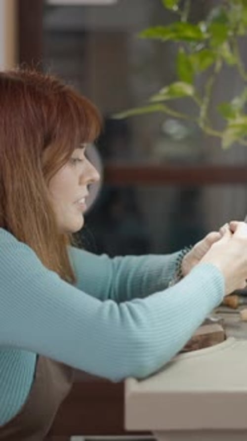 Woman Creating Small Sculpture at Table