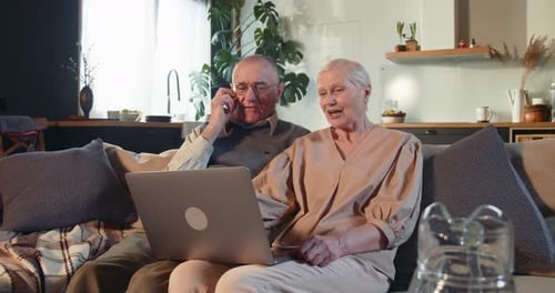 Elderly Couple Using Laptop at Home