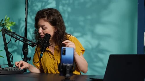 Content Creator Using Smartphone to Film ASMR Video Tapping on Mic