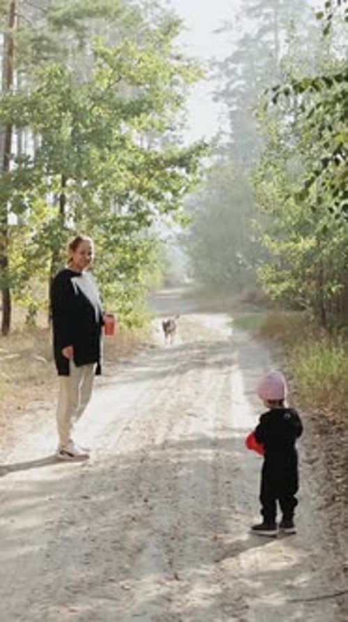 Vertical Video Shoot of a Child and an Mother Walk Along a Serene Path in the Beautiful and Peaceful