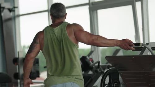 Man Stretching After Workout in a Modern Gym