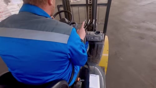 View From the Back of the Forklift Driver Driving Through the Hangar