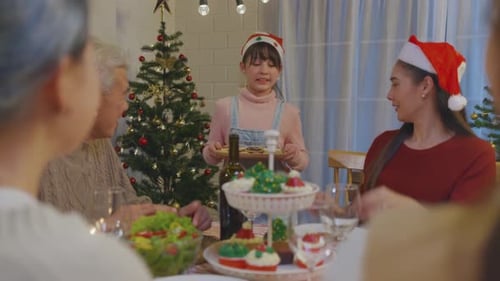 Family Celebrates Christmas Dinner Together at Home