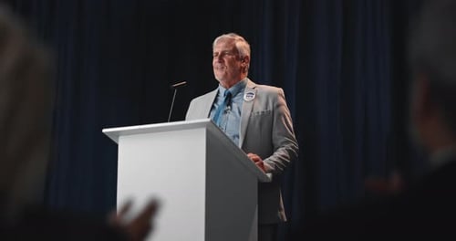 Man Giving Speech at Podium, Corporate Setting