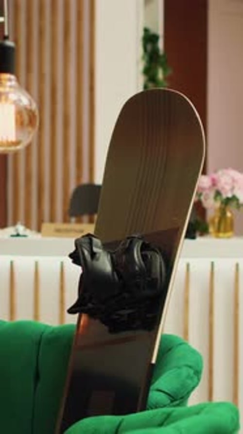 Vertical Video Skies and Snowboard in Lounge Area