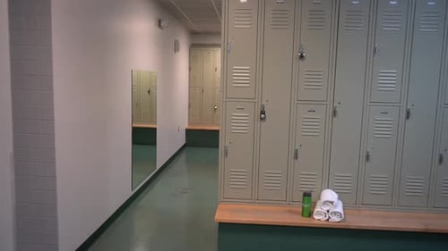 Empty Locker Room with Rows of Pale-Grey Metal Lockers