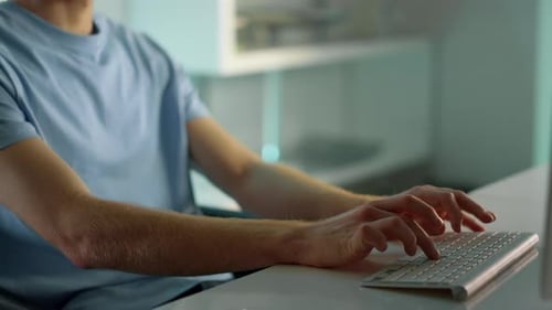 Closeup Hands Typing Computer Keyboard. Focused Man Writing Email At Home Office. Serious Freelan...
