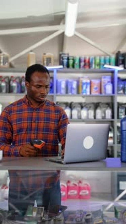 Man Scans Parts at Auto Store Counter