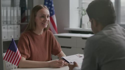 Woman Having Visa Interview with Consular Officer at US Embassy