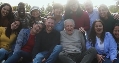 Multigenerational friends enjoying a day together at central park USA hugging and smiling