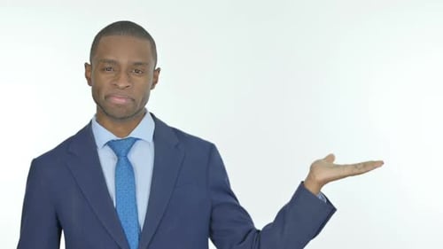 African Businessman Showing on Side on White Background