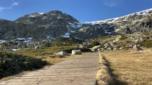 Hiker On Boardwalk Entering Mountain Trek In National Park, Spain