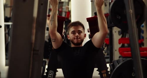 Caucasian Man is Engaged in the Gym on the Simulator Exercise Thrust