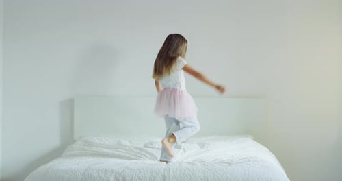 Happy Girl Dances, Jumps on Bed Wearing Tutu