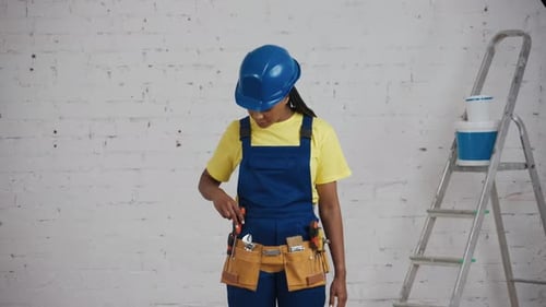 Woman in Hard Hat Gives Thumbs Up