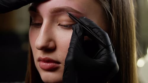 Close Up of Eyebrow Shaping with Tweezers