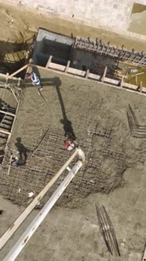 Aerial View of Construction Workers Pouring Concrete