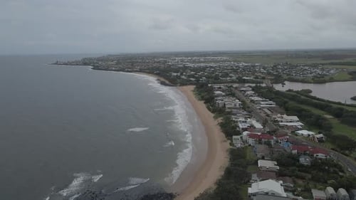 Coastal Town And Beach On A Cloudy Day In Bundaberg, Queensland, Australia - aerial drone shot