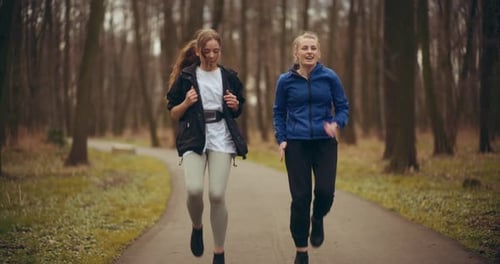 Two Woman Workout Exercising In Park Jogging Fitness