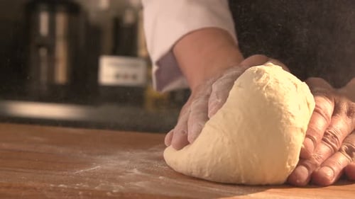 Cook Is Making A Cake. Hands Kneading Dough In Flour On Table, Dolly Shot. Slow Mo. Close-Up