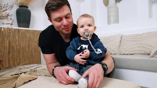 Loving Father Holding Adorable Infant Child