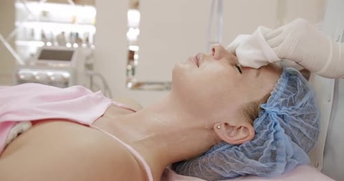 Woman Receiving Gentle Facial Treatment in Clinic