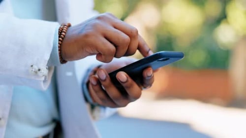 Hands, typing and phone in city for social media, texting or web scrolling outdoors in street