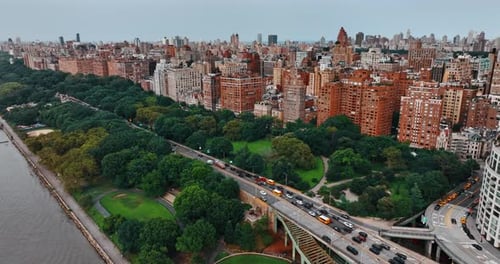 Lush greenery on both sides of busy highway on the waterfront of Hudson River.