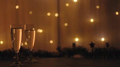 Festive Champagne Glasses with Garland and Twinkling Lights