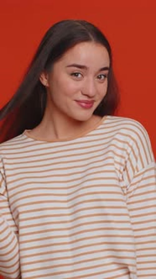 Smiling Woman with Long Hair Twirling it on Finger