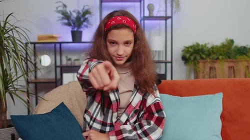 Preteen Girl Smiling Pointing to Camera Choosing Lucky Winner Indicating Inviting Approve at Home